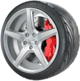 A Close-Up Of A Tire With Red Brake Pads And A Sleek Silver Rim, Showcasing Modern Design.